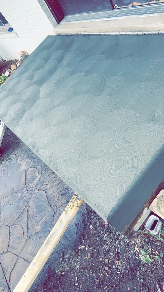 Fresh concrete entry landing with a decorative swirl finish