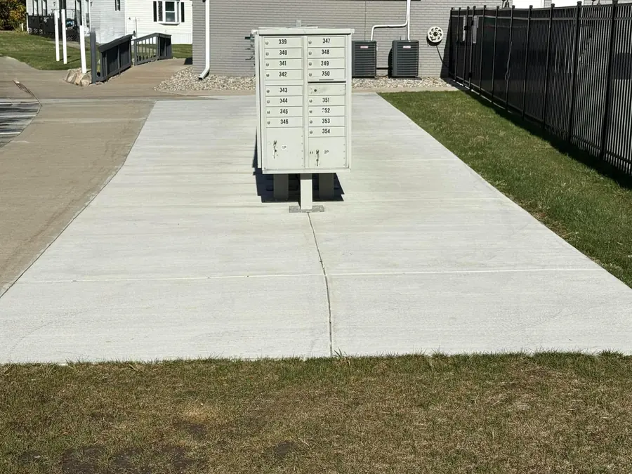 New commercial concrete pad surrounding a cluster mailbox station