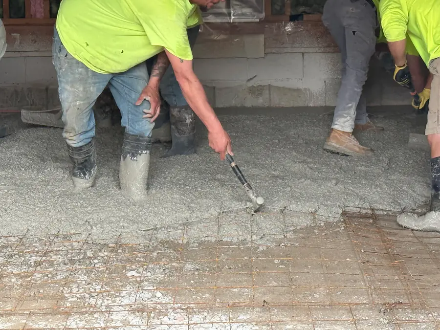 Crew screeding and finishing freshly placed concrete