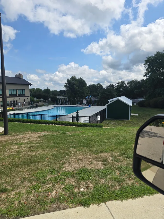 Finished concrete deck surrounding a community swimming pool