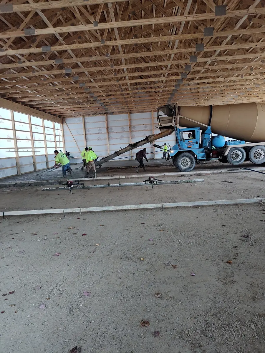 Concrete crew placing a large slab inside a commercial building