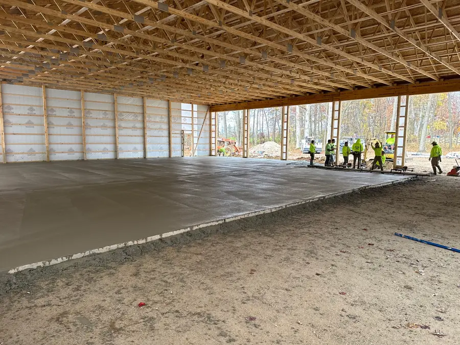 Large concrete slab being installed inside a covered structure