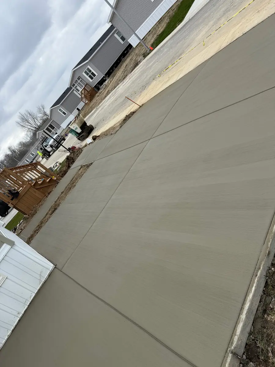 Extended residential concrete driveway with a smooth finished surface