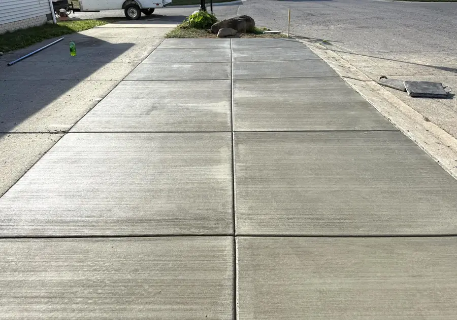 New concrete driveway with control joints and a broom finish