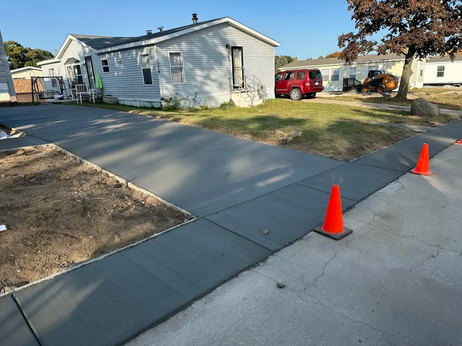New residential concrete driveway connecting to the street