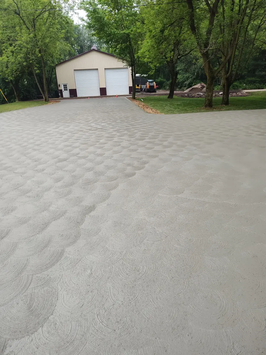 Wide residential concrete driveway with a decorative swirl finish